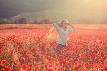 Fototapeta premium Woman portrait on poppy field