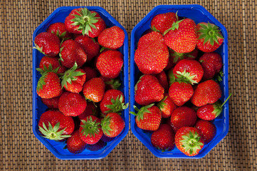 Two boxes filled with fresh red strawberries. View from above.