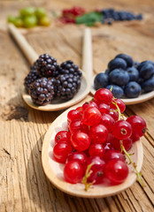 Currants and blueberries on a wooden table