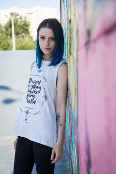 Young beautiful girl agains graffiti wall