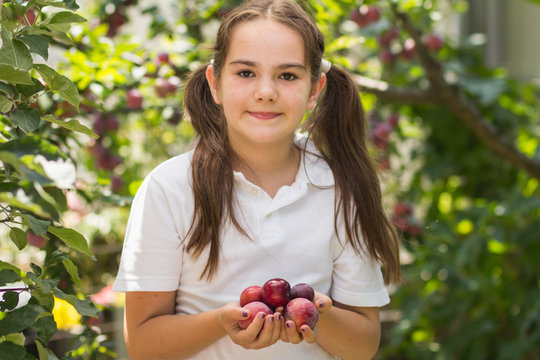 little girl holding fruit