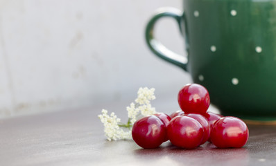 Red cherry and green cup