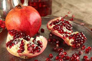 Pomegranate seeds on metal tray, closeup