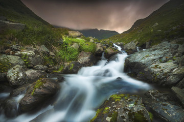 Waterfall up in the mountains during sunset