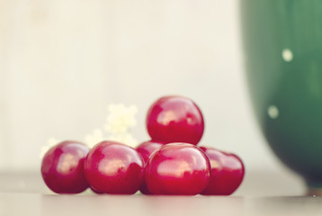 Red cherry and green cup