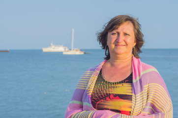 Fototapeta premium Portrait of a woman against the sea
