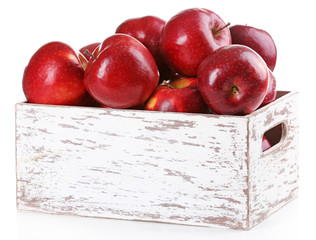 Red apples in wooden crate isolate on white