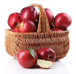 Red apples in wicker basket isolate on white