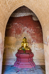 Golden ancient Buddha statue at Htilo Minlo Pagoda, Bagan, Myanm