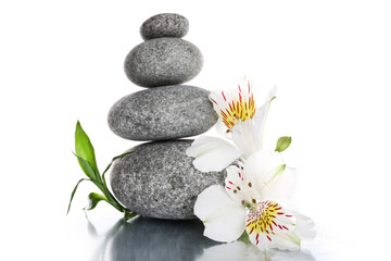 Stack of spa stones with flower isolated on white