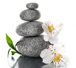 Obraz na płótnie Canvas Stack of spa stones with flower isolated on white