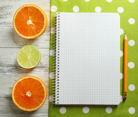 Open recipe book, napkin on wooden background