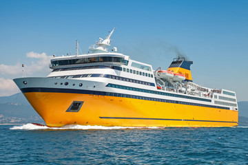 Fototapeta na wymiar Big yellow passenger ferry goes on the Sea