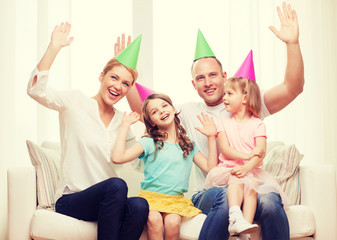 happy family with two kids in hats celebrating