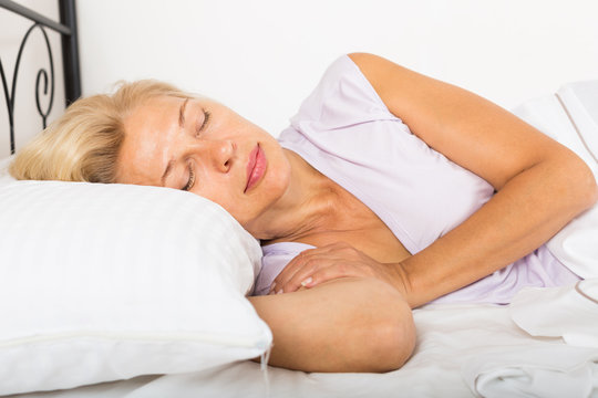 Middle-aged woman sleeping in bed