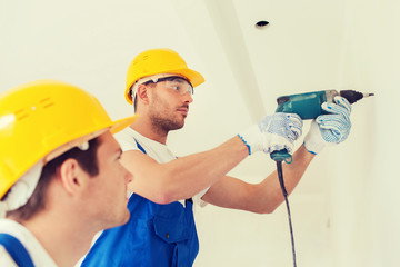 group of builders with drill indoors