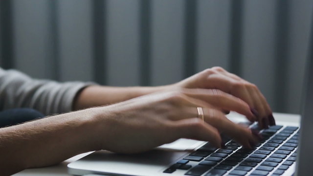 Work with a  laptop typeing on a keyboard