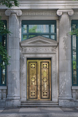 brass door with stone columns on bank building
