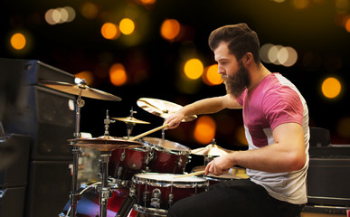 male musician playing cymbals at music concert