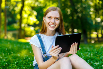 Fototapeta premium Beautiful smiling red-haired young woman
