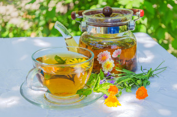 Herbal tea in teapot and cup