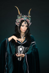 Beautiful fantasy elf woman in flower crown and medieval dress