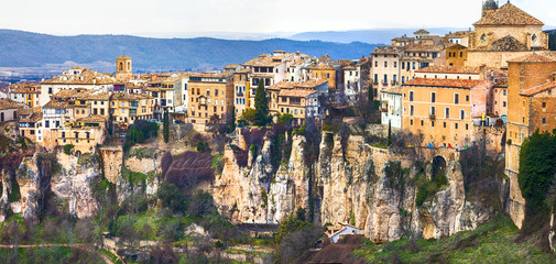 Fototapeta premium Cuenca Spain panorama 8k of medieval town with famous hanging houses on rocks. Scenic view of UNESCO world heritage site Casas Colgadas on cliffside. Historic architecture of Castilla La Mancha
