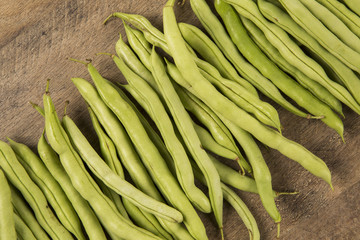 small and slender green beans (haricot vert) on a wood