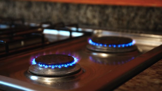 Ignite on gas stove at the kitchen, closeup
