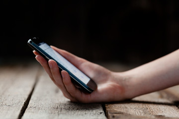 mock up of smart phone and girl holding it over a wooden table