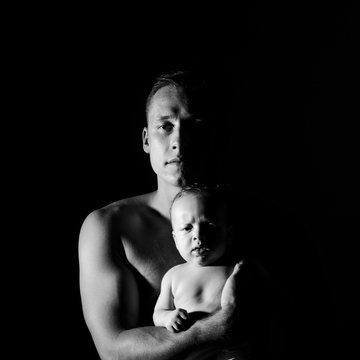 Black And White Portrait Of Father And His Newborn Son