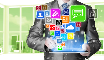 Business man using tablet PC with social media icon set