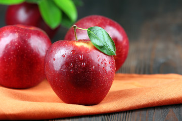 Ripe red apples on table close up