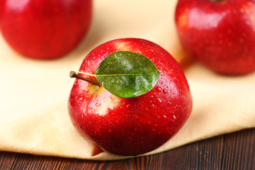 Ripe red apples on table close up