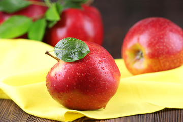 Ripe red apples on table close up
