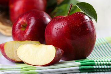 Ripe red apples on table close up