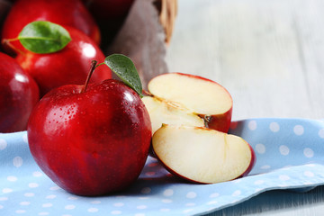 Ripe red apples on table close up