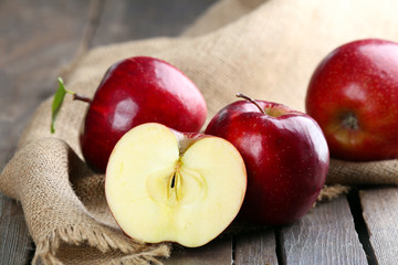Ripe red apples on table close up