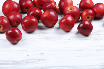 Heap of ripe red apples on wooden background