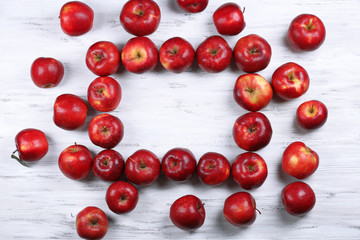 Heap of ripe red apples on wooden background