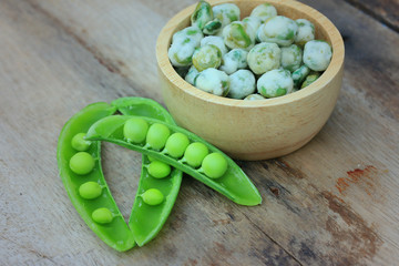 Fresh green soybeans and coated nuts on wood vintage