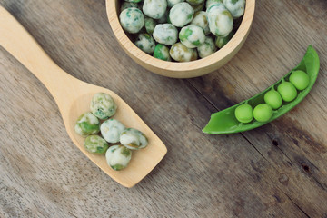 Fresh green soybeans and coated nuts on wood vintage