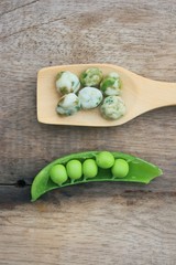 Fresh green soybeans and coated nuts on wood vintage