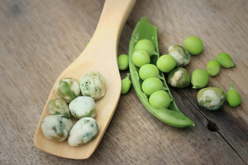 Fresh green soybeans and coated nuts on wood vintage