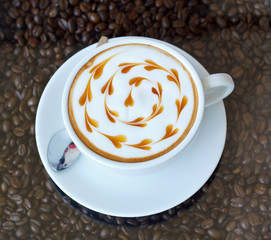 Hot coffee with heart pattern in white cup