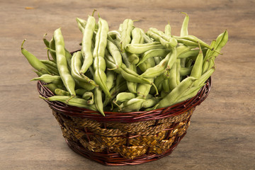small and slender green beans (haricot vert) on a wood
