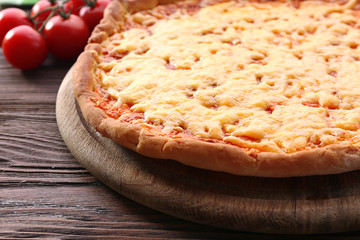 Cheese pizza with cherry tomatoes on table close up
