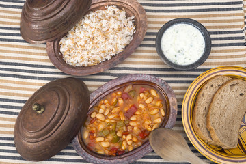 Turkish traditional meal, beans, rice, mixed pickles and tzatziki
