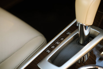 tan leather seat and stick shift of American family sedan