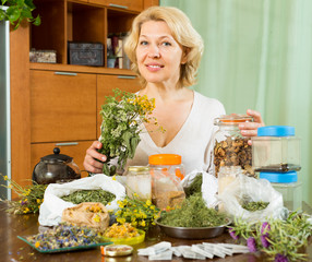 Smiling  mature woman with herbs in home